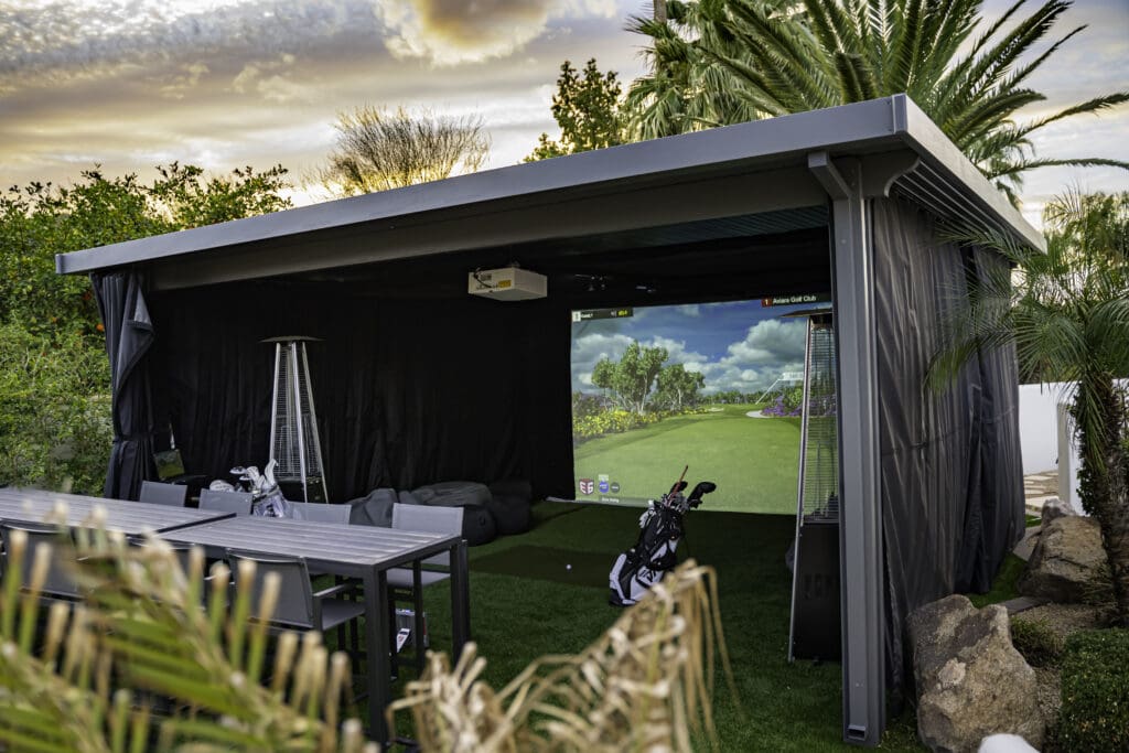 An outdoor golf simulator brings the excitement of a golf game right to your screened-in patio.