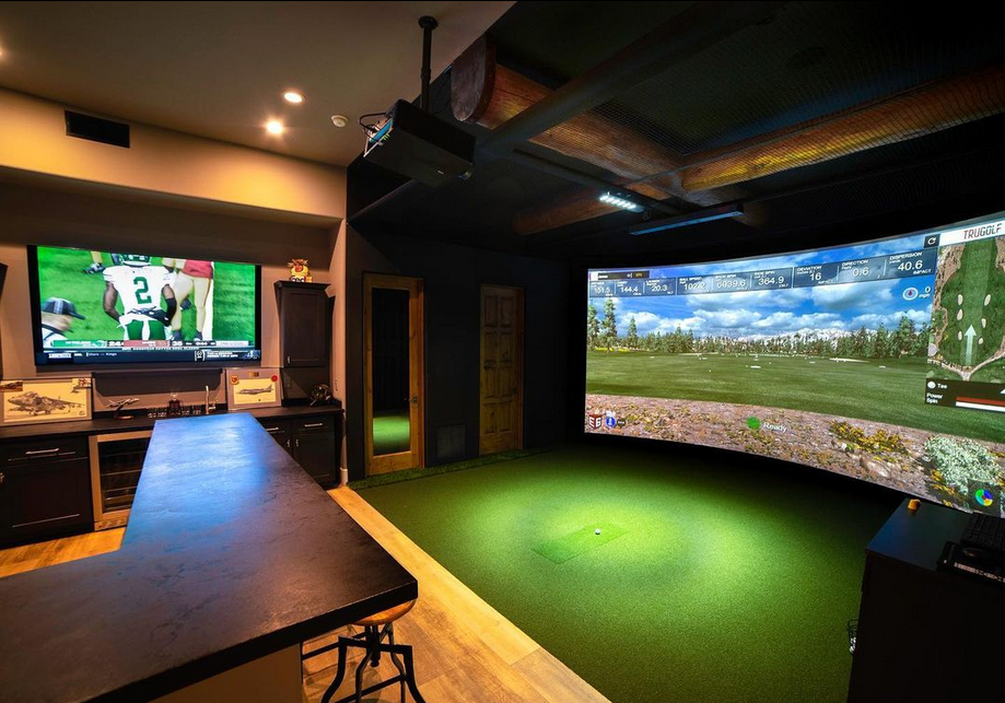 Man cave with golf simulator and bar.