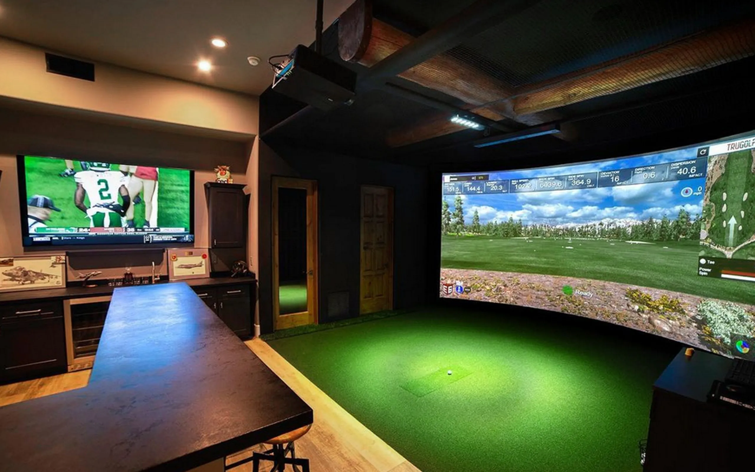 Entertainment room with golf simulator and built-in bar