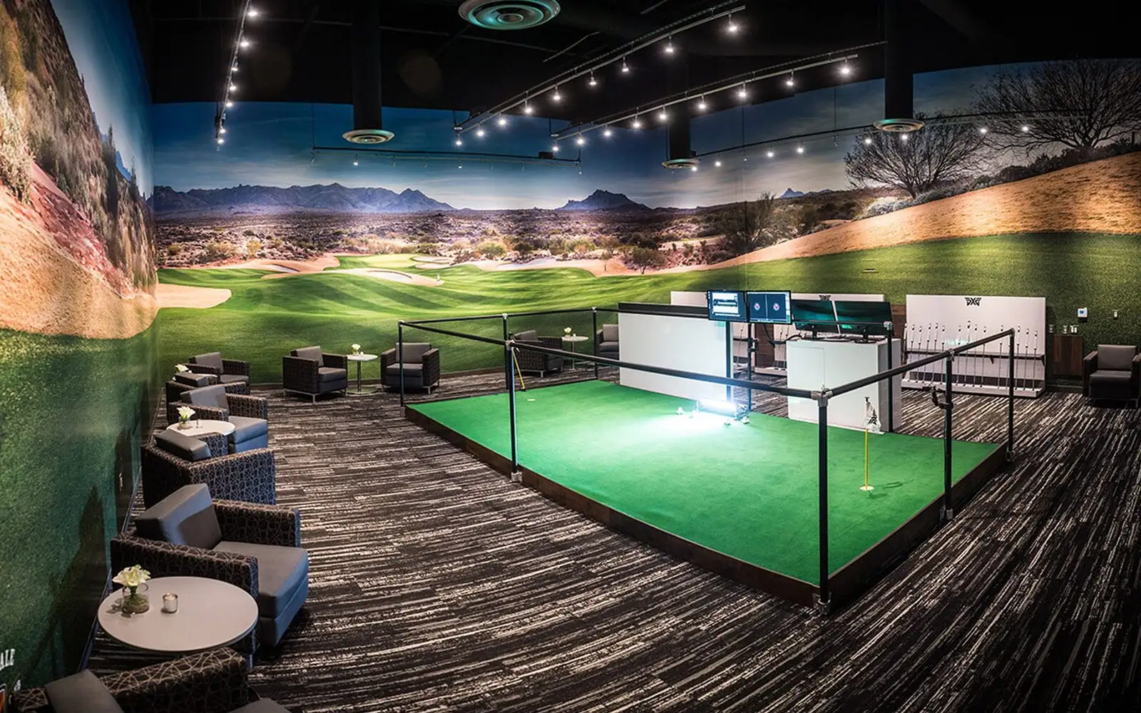 Luxury custom-built golf simulator room with curved screen and lounge seating
